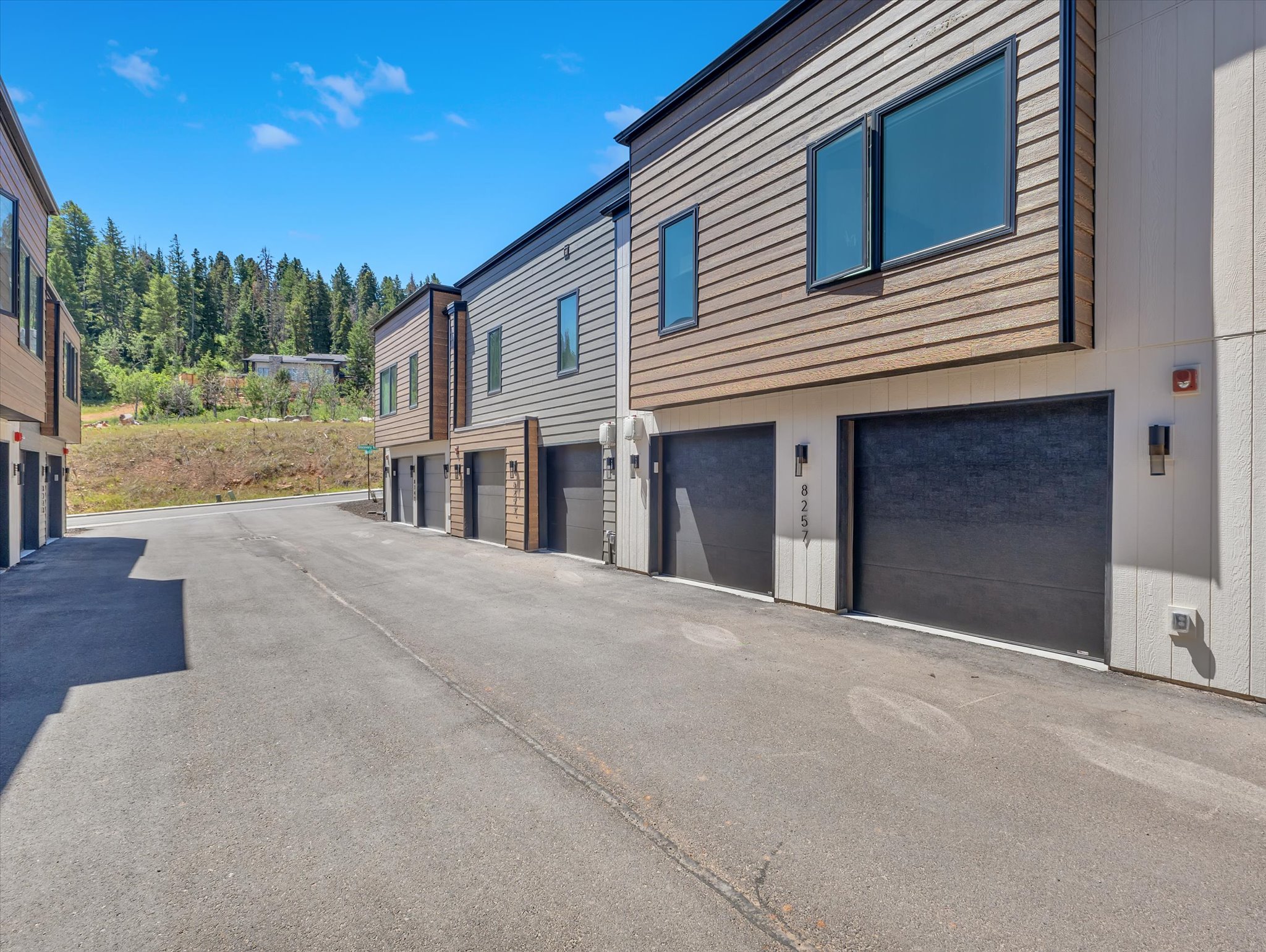 Contemporary townhome exteriors featuring horizontal siding and vertical paneling