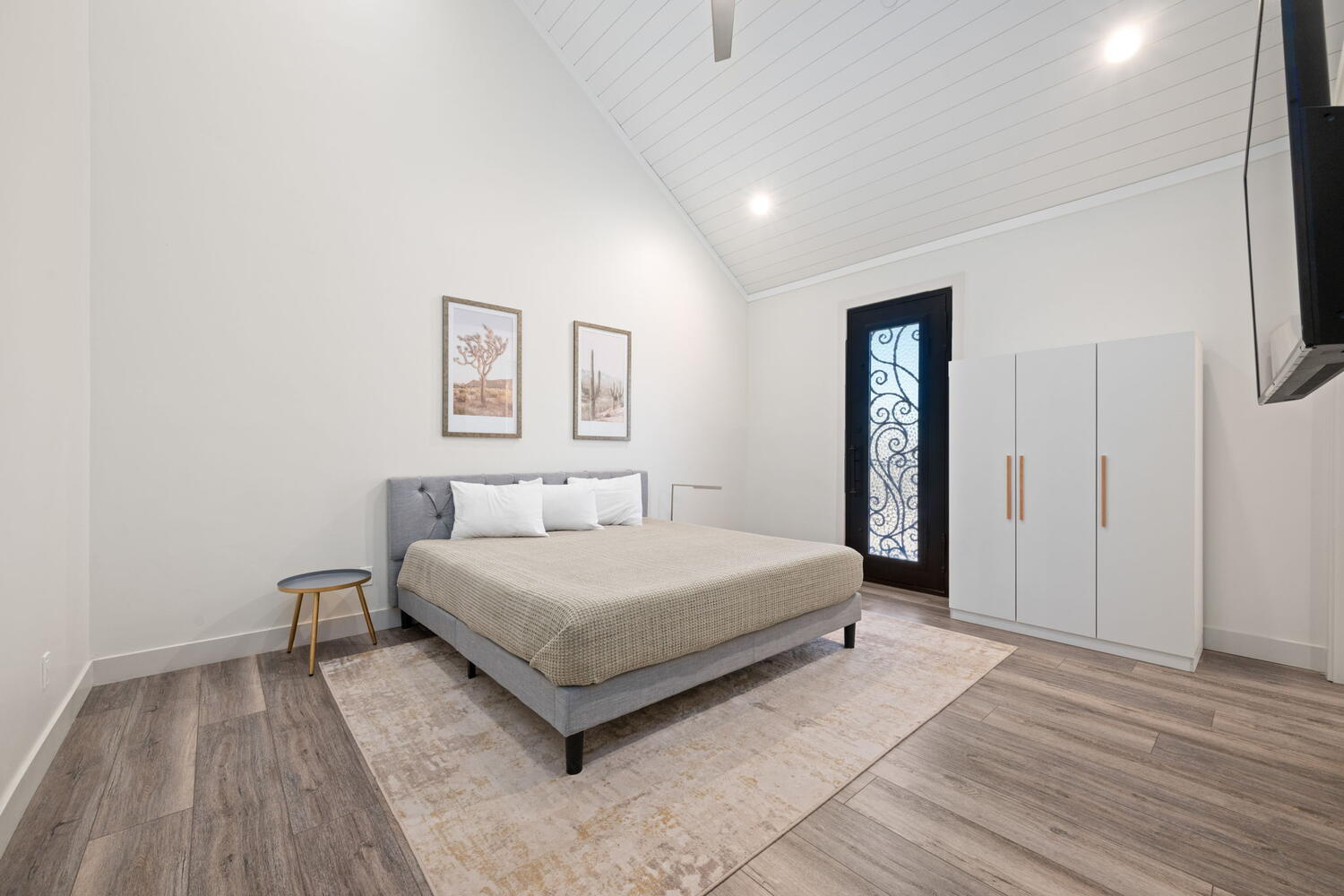 Vaulted ceiling with wood-plank finish and recessed lighting