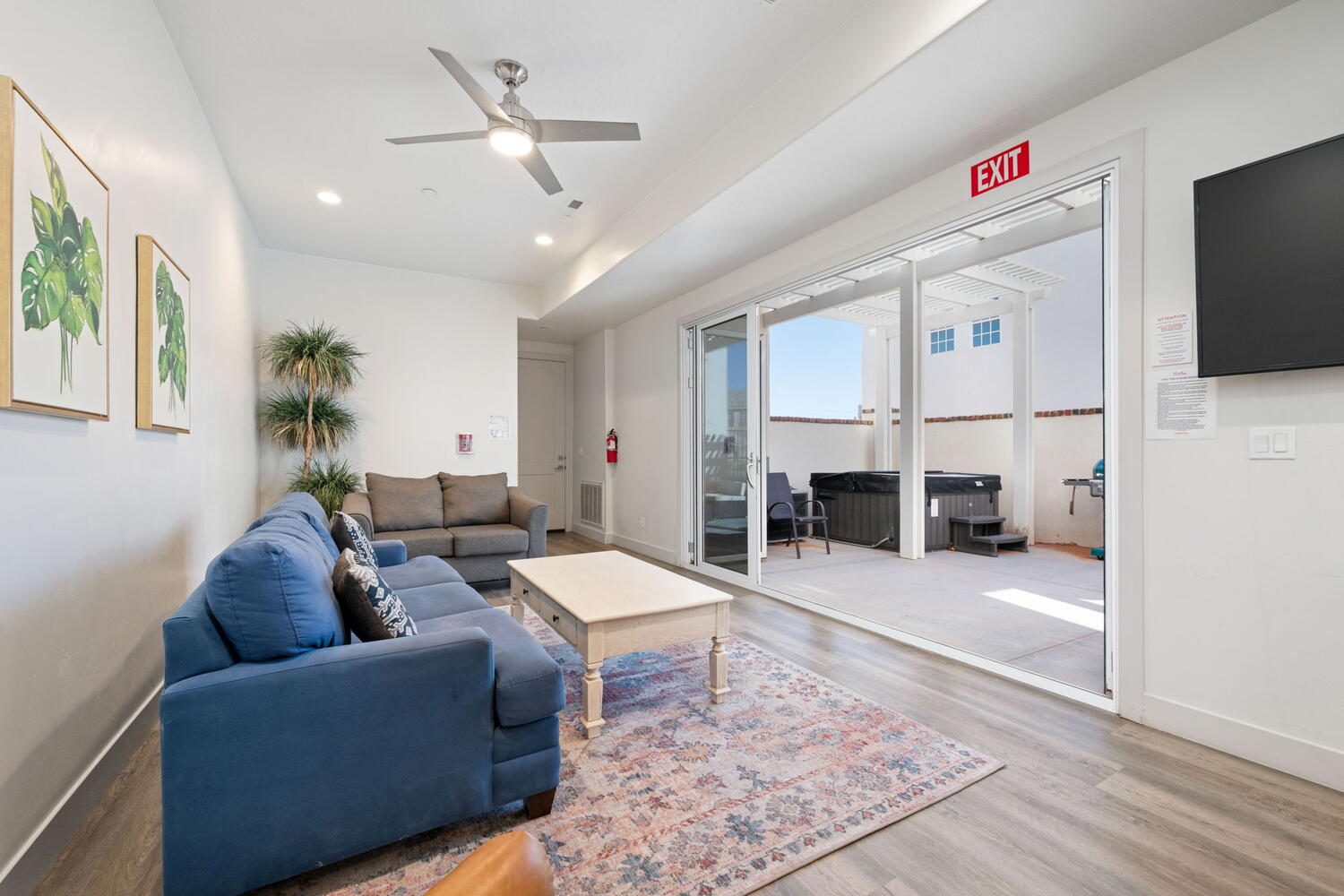 Spacious living area featuring wood-finish flooring, recessed lighting, and a modern ceiling fan