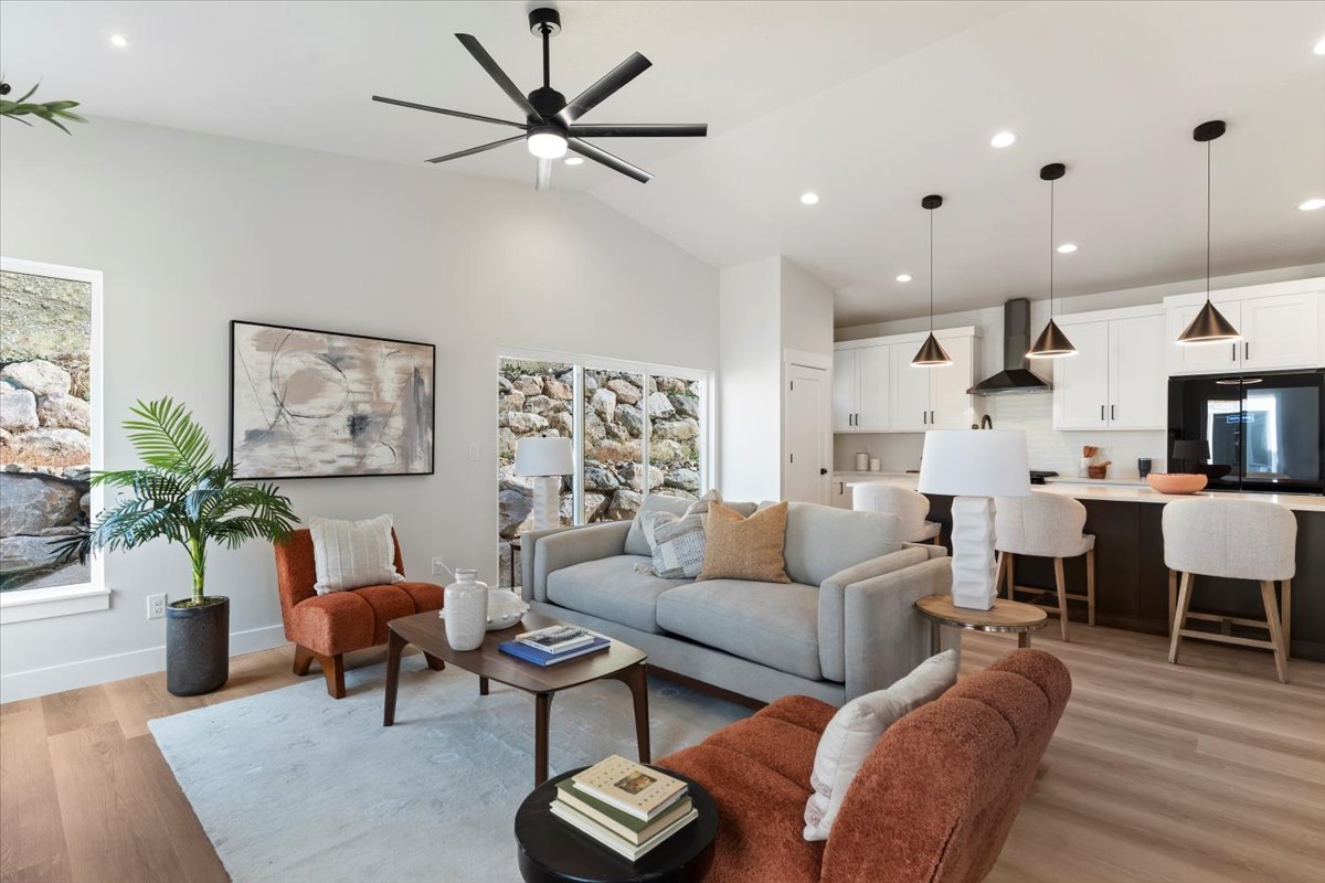 Open concept living space featuring vaulted ceilings, wood-finish flooring, recessed lighting, and a modern ceiling fan