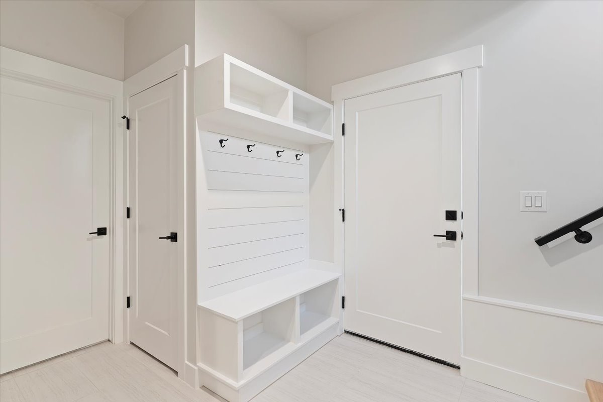 Built-in mudroom bench with cubby storage and coat hooks