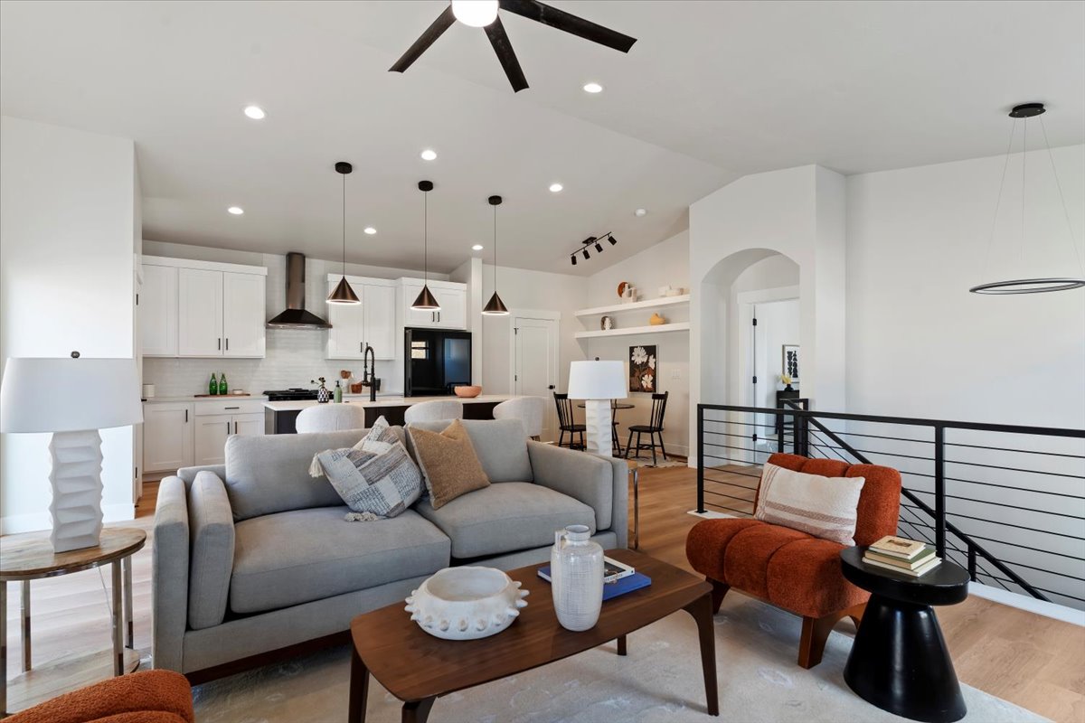 Open-concept living space with vaulted ceilings and recessed lighting