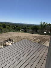 Outdoor deck featuring wood-finish composite decking and a broad landscape