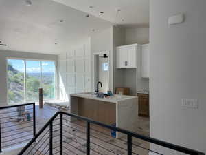 Open-concept living area featuring an expansive window wall showcasing distant terrain