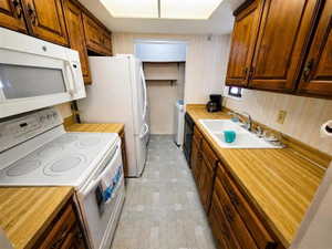 Kitchen featuring wood-finish countertops and rich wood cabinetry
