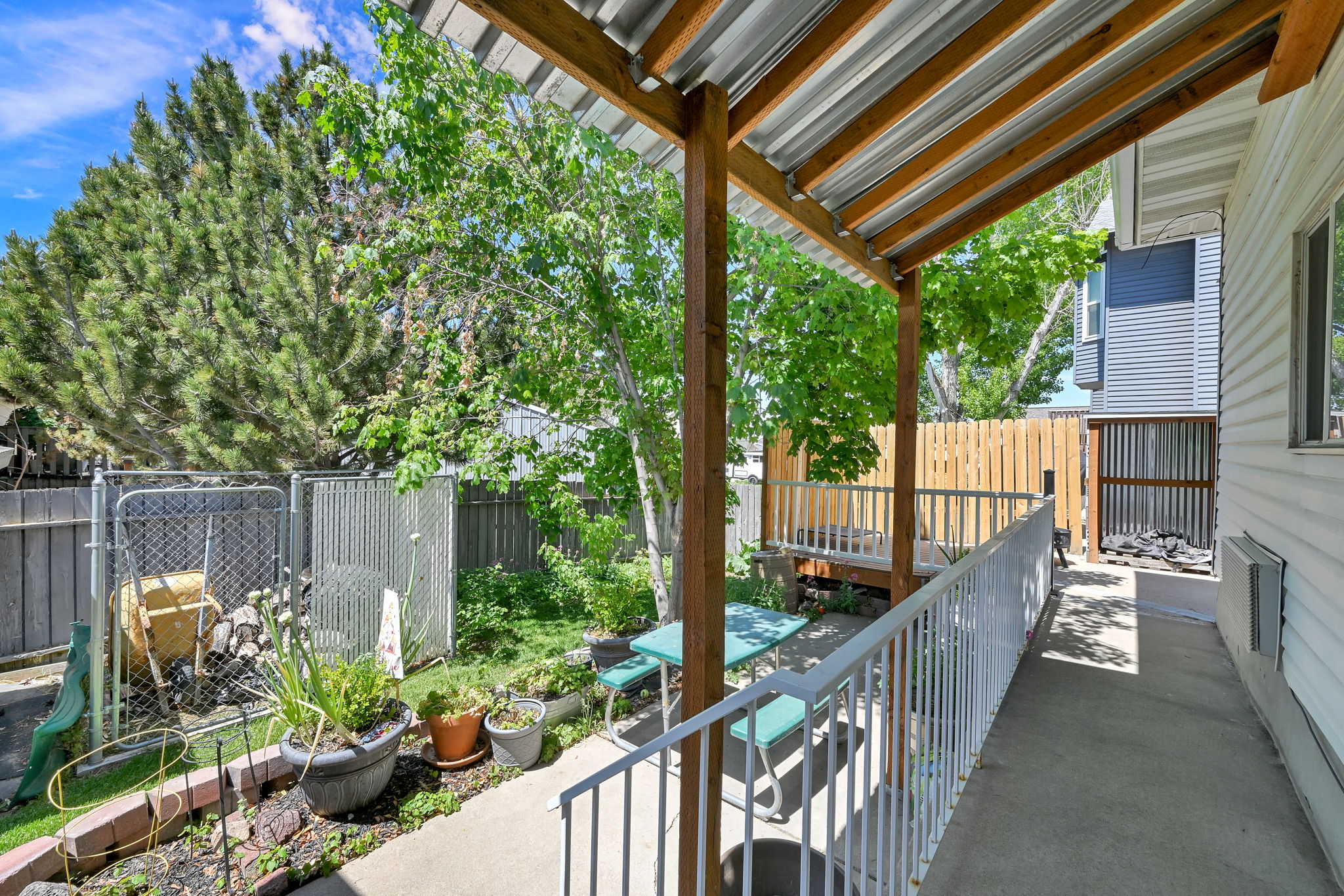Covered patio with a corrugated metal roof and exposed wood beams
