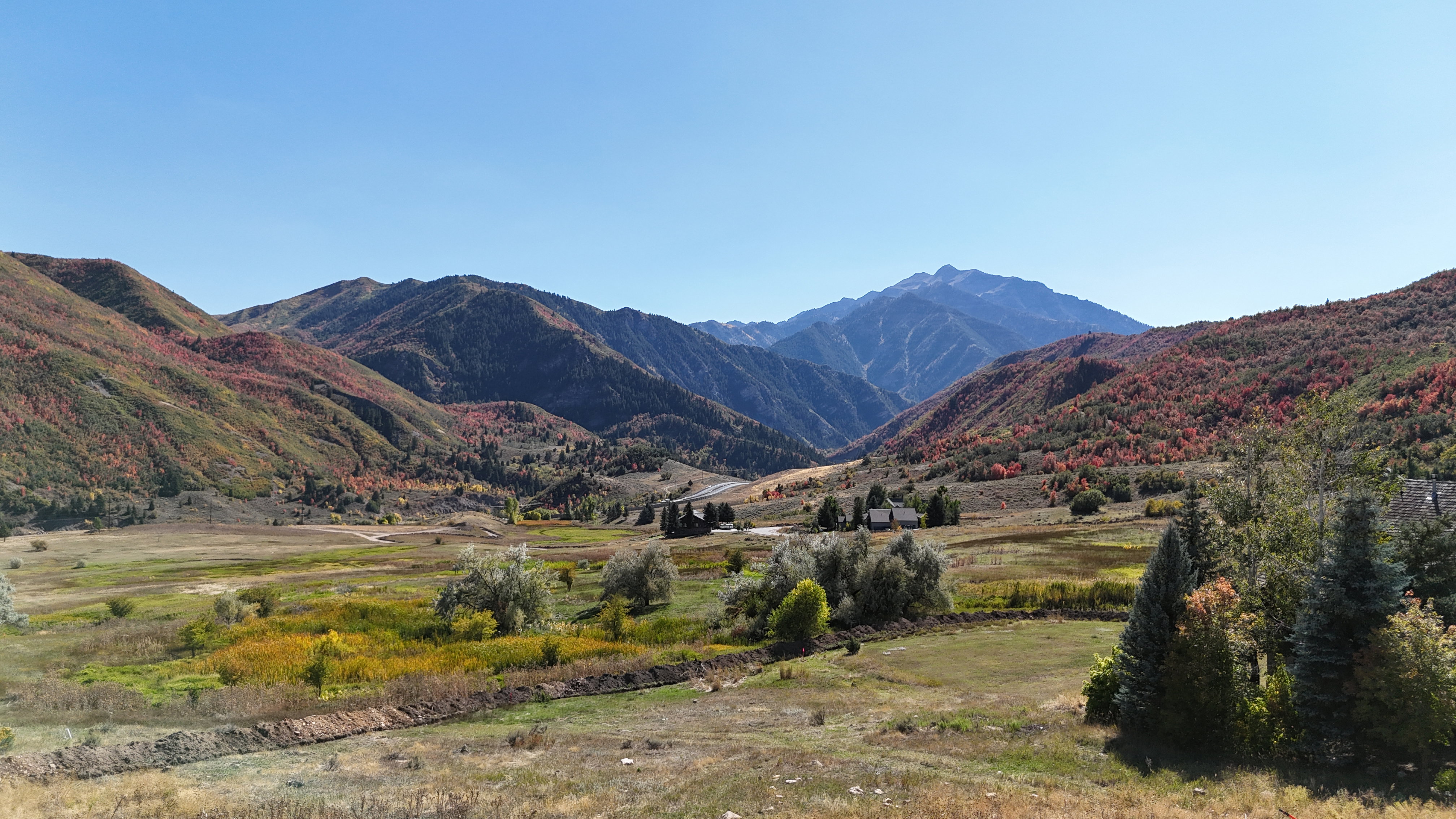 Expansive mountain landscape featuring varied terrain and natural foliage