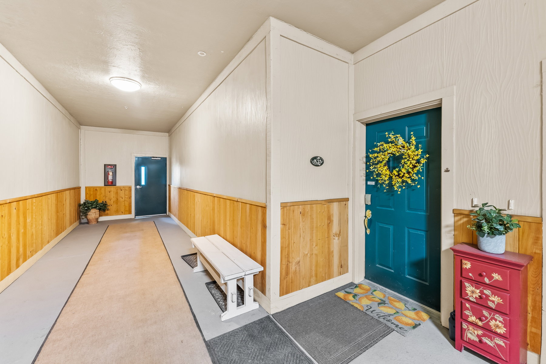 Entryway featuring wood paneling, light wall finishes, and a flush-mount ceiling light