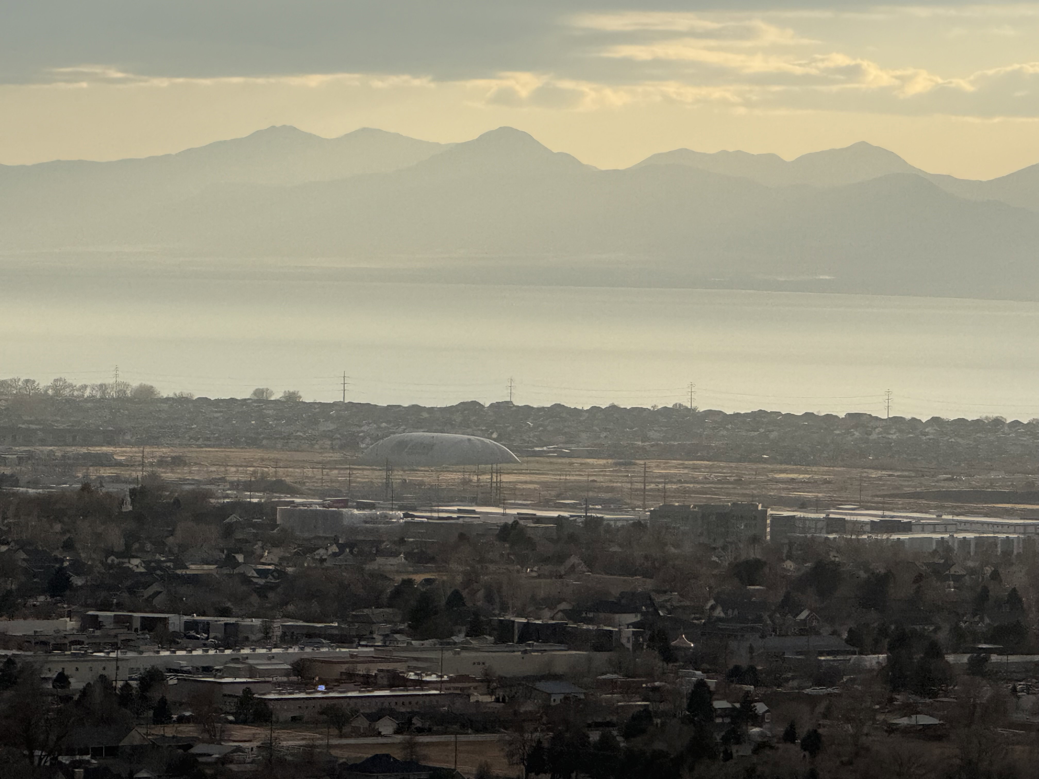 Distant mountain range and a large body of water framing a residential and commercial area
