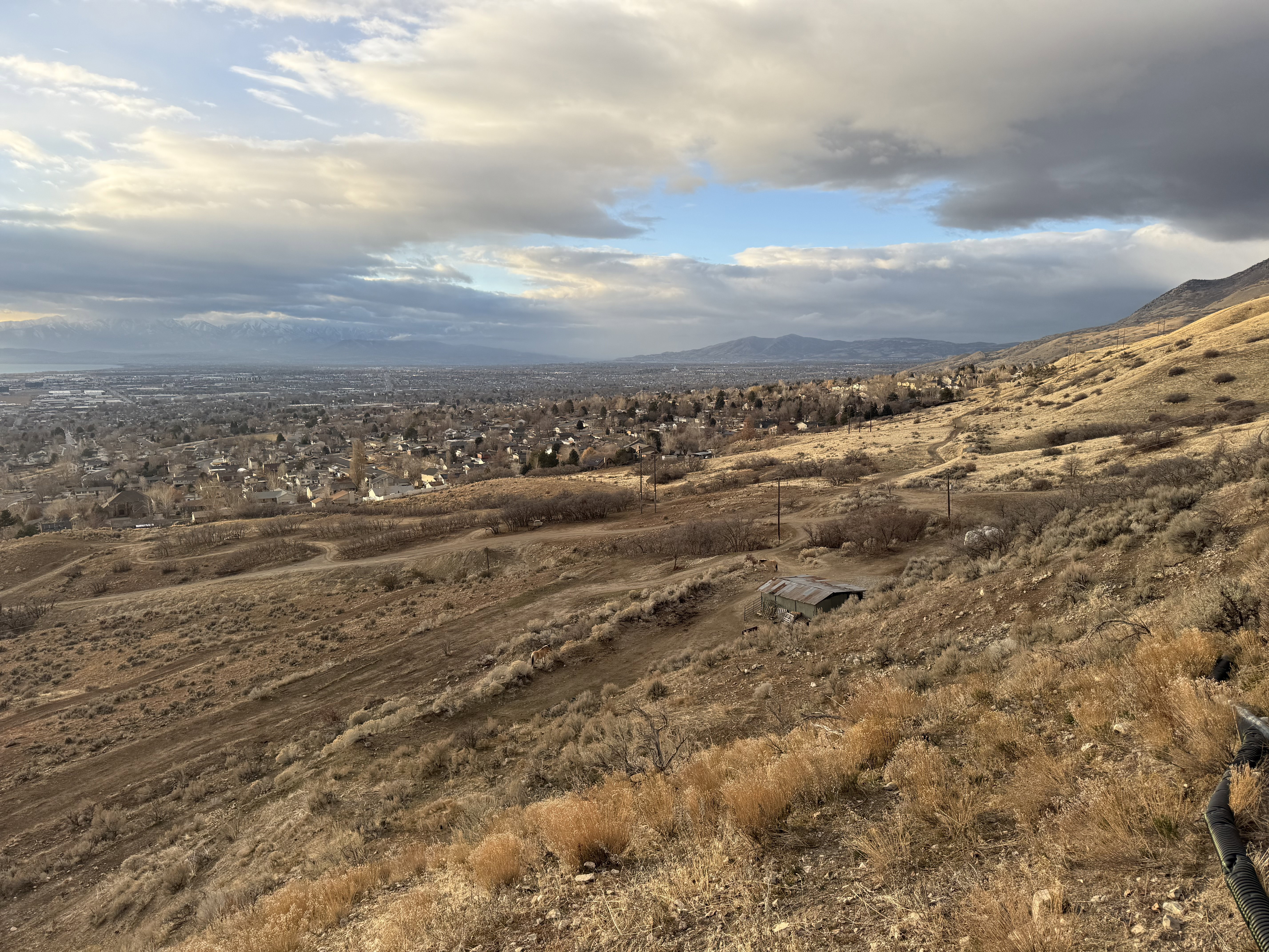 Expansive elevated lot featuring natural terrain and distant urban scenery