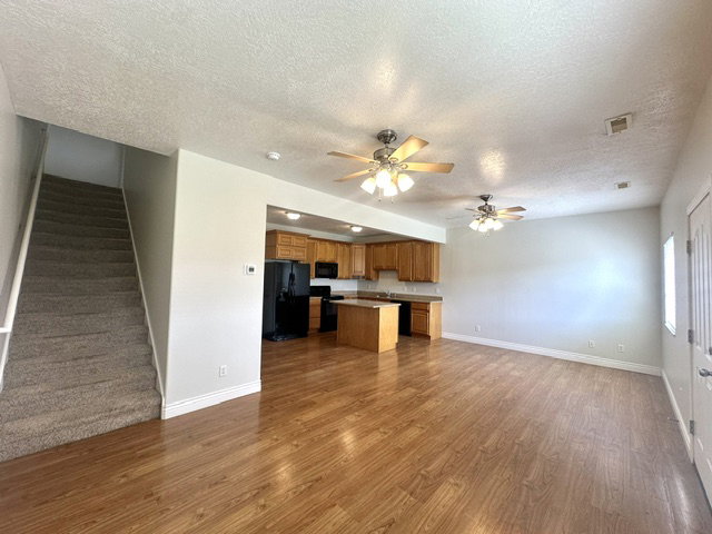 Open concept living space featuring wood-finish flooring