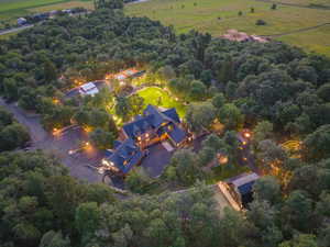 Expansive property featuring a multi-structure estate surrounded by mature trees