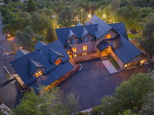 Expansive property featuring a multi-level structure with a dark metal roof and light-toned siding
