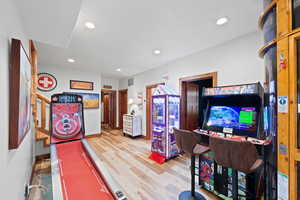 Recessed lighting illuminating wood-finish flooring