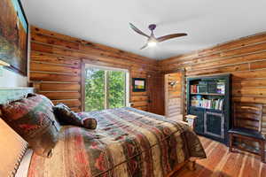 Wood-finish flooring and log walls create an authentic cabin aesthetic
