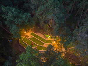 Terraced miniature golf course surrounded by mature trees