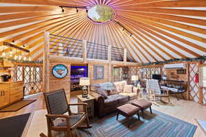 Vaulted ceiling with exposed wood beams and central skylight