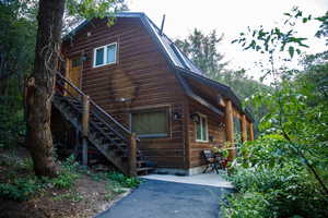 Wood-sided property with a distinctive gambrel roofline