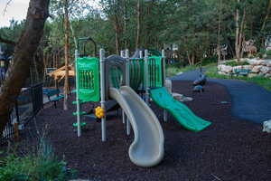 Recreational playground featuring two slides, climbing elements, and a surrounding path