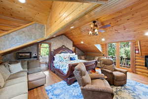 Spacious room featuring wood-finish flooring and a wood-paneled ceiling