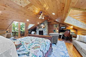 Wood-paneled room with vaulted ceilings, log walls, and wood-finish flooring