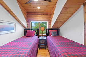 Room featuring wood-plank ceilings, exposed wood beams, and wood-finish flooring