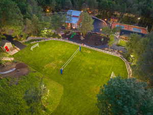 Expansive lawn featuring a volleyball net and two soccer goals