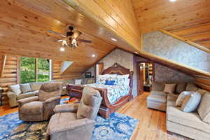 Vaulted wood-paneled ceilings with recessed lighting and a ceiling fan