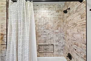Shower/tub combination featuring white subway tile walls with a distressed wood-look finish, a built-in shower niche with matte black trim, and a matte black shower head and faucet