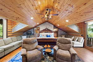 Expansive wood-paneled ceiling with recessed lighting and a central ceiling fan
