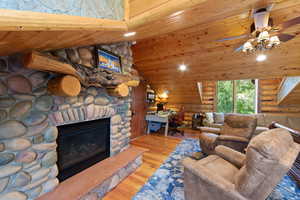 River rock fireplace with a rustic wood mantel