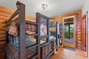Interior room featuring log walls and wood-finish flooring