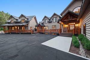 Expansive asphalt driveway with concrete walkways complementing the multi-unit property