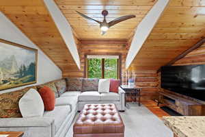 Wood-paneled ceilings with exposed beams and a contemporary ceiling fan