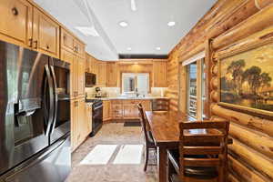 Kitchen featuring wood cabinetry, stainless steel appliances, recessed lighting, and a stone-finish countertop with a matching backsplash