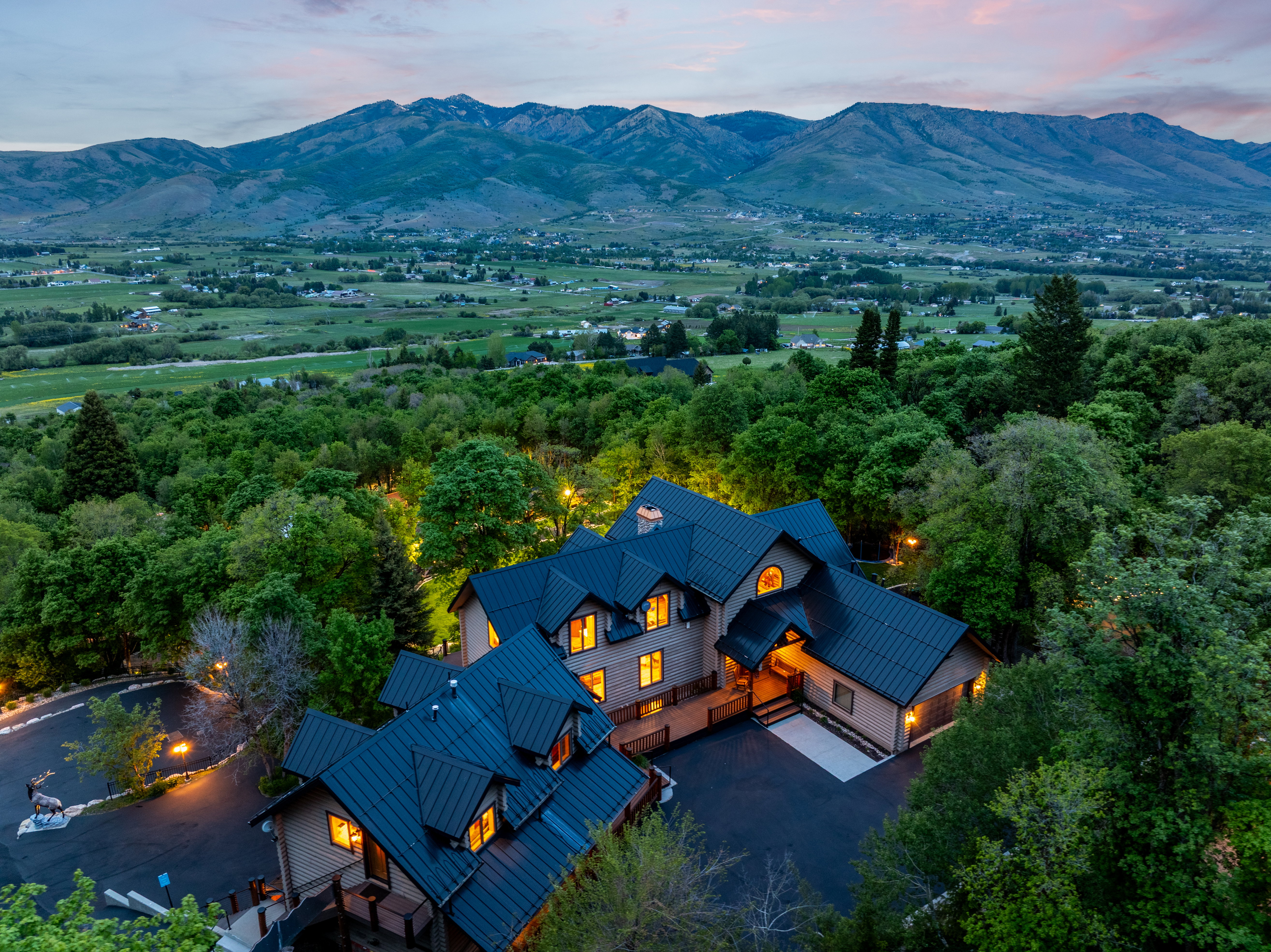 Expansive estate featuring a multi-level architectural design with dark metal roofing