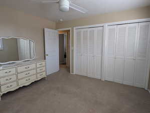 Master bedroom with wall-to-wall carpeting and neutral wall tones
