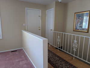 Front door with half-wall separating the living room from the entry