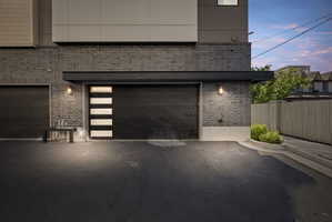 Garage featuring asphalt driveway