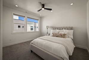 Carpeted bedroom with ceiling fan, recessed lighting, and a textured ceiling
