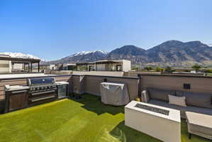 View of patio / terrace with a mountain view, grilling area, and an outdoor living space with a fire pit