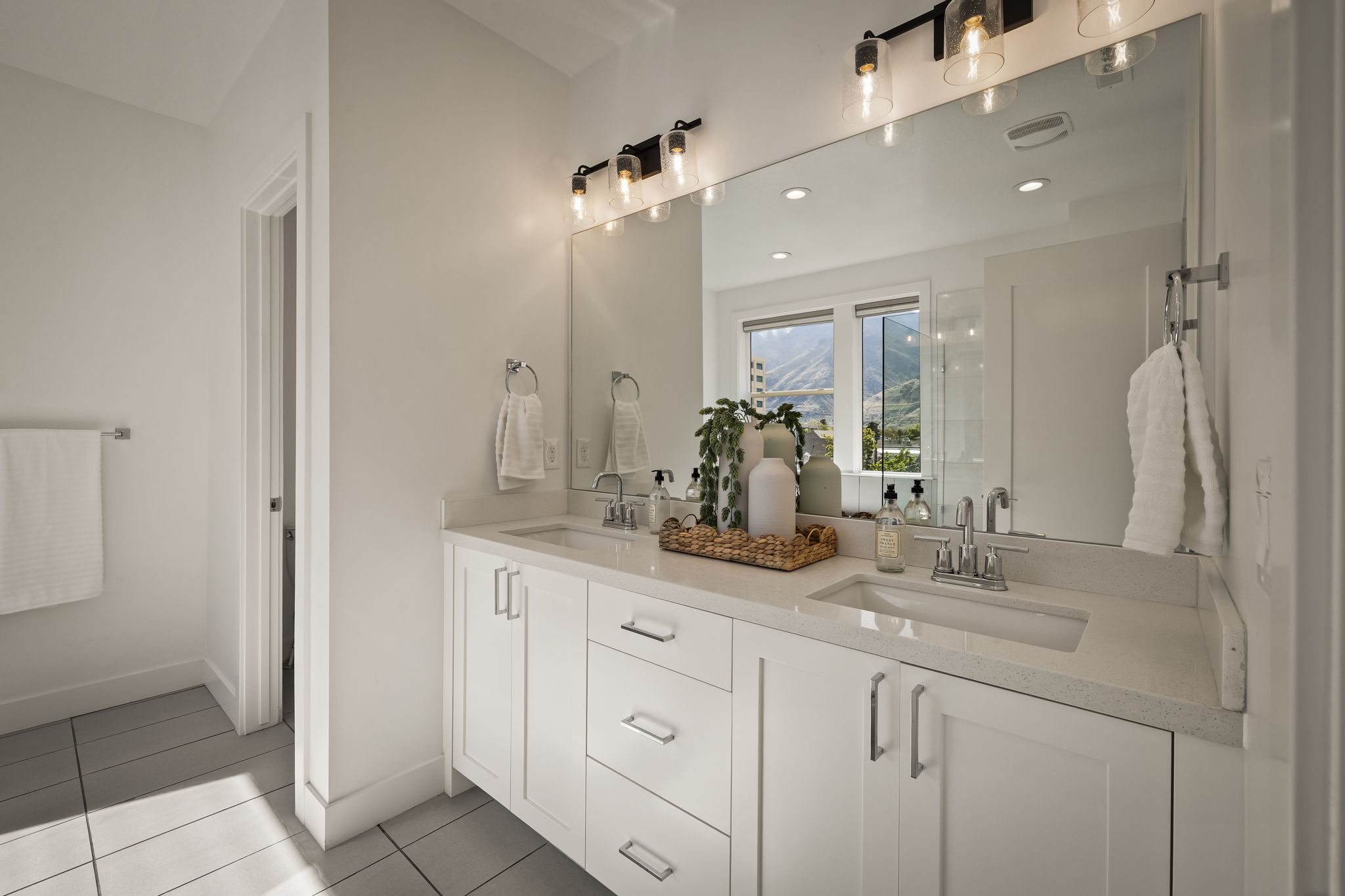 Full bath with double vanity, light tile patterned flooring, and recessed lighting