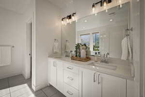 Full bath with double vanity, light tile patterned flooring, and recessed lighting