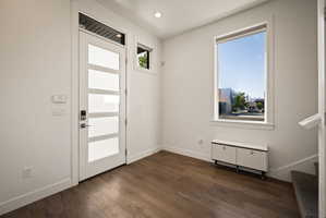 Foyer featuring radiator heating unit and dark wood finished floors