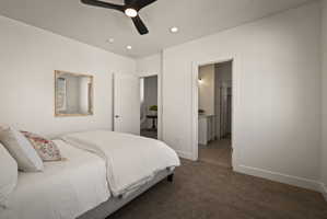 Carpeted bedroom featuring a ceiling fan, recessed lighting, and ensuite bath
