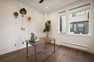 Home office featuring baseboard heating, dark wood-type flooring, ceiling fan, and recessed lighting