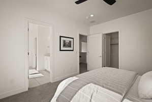 Carpeted bedroom featuring ceiling fan, a walk in closet, and recessed lighting