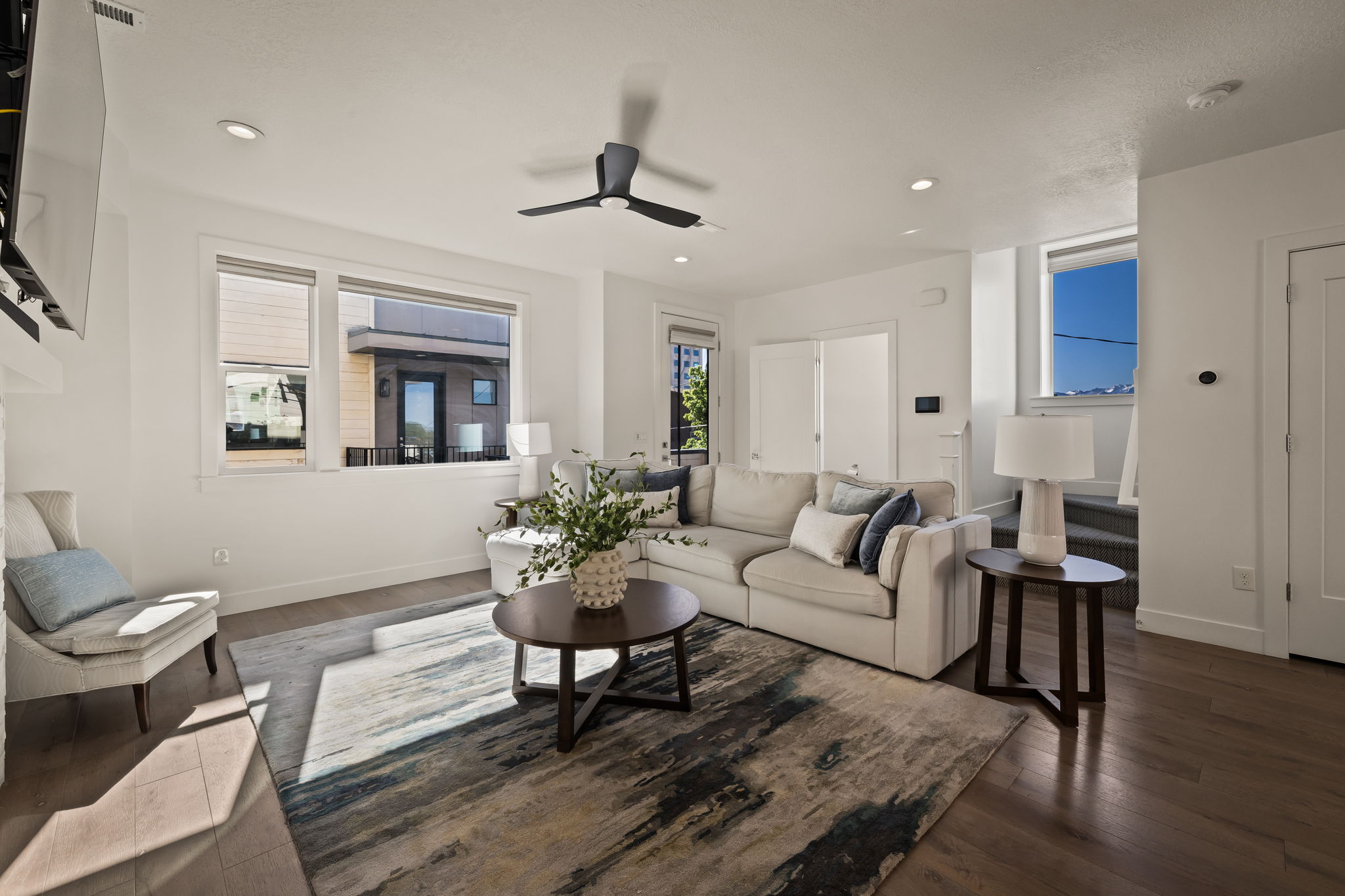 Living room with ceiling fan, dark wood-style floors, and recessed lighting