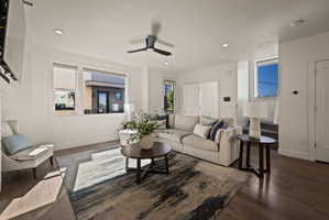 Living room with ceiling fan, dark wood-style floors, and recessed lighting