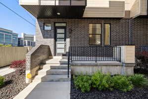 Doorway to property featuring brick siding